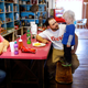 Employee Joyce Chandler looks on as Antonin Bohac encourages his son, Sawyer, to eat in Bixby